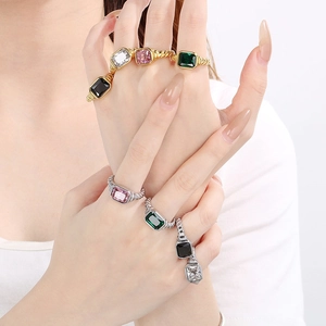 Macro shot of twisted rope texture and colorful rectangular gemstones on metal rings