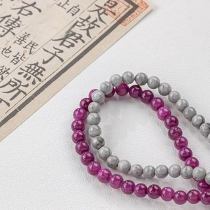 Close-up of natural dark purple and grey round jade beads for DIY jewelry making