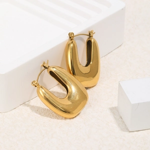 Polished 18K gold plated stainless steel U-shaped chunky hoop earrings on white tray