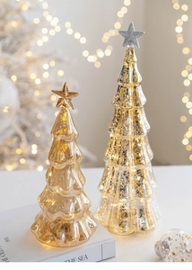 Close-up of mercury glass Christmas trees with warm LED lights and mottled texture