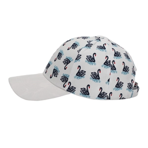 Close-up of white cotton baseball cap featuring all-over black swan pattern and flat brim