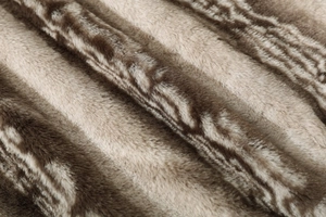 Detailed close-up of faux fur lining with plush brown and beige stripes on winter coat
