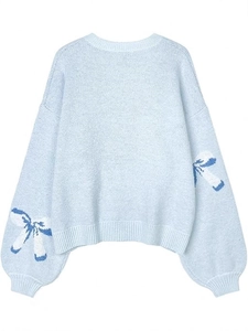 Light blue knit sweater with decorative bows on sleeves and classic crew neck
