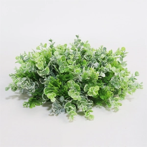 Close-up of frosted artificial eucalyptus wreath leaves with white flocking details