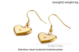 Close-up of heart-shaped gold stainless steel earrings with tiny inlaid crystal