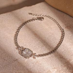 Detailed macro view of silver zircon pendant necklace with flat cuban chain and lobster clasp