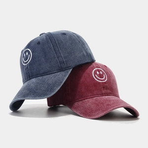 Washed cotton baseball caps with embroidered smiley face in dark denim blue and burgundy