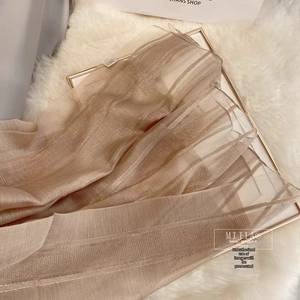 Detail of champagne striped silk wool fabric with metallic gold thread and soft texture