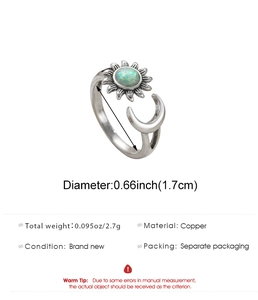 Detail view of adjustable sun and moon ring with green stone on white background