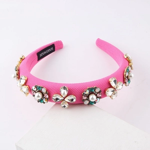 Macro detail of handmade rose pink braided headband with baroque pearls and crystals