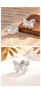 Detailed macro view of butterfly stud earring featuring heart-shaped zircon and micro-pave