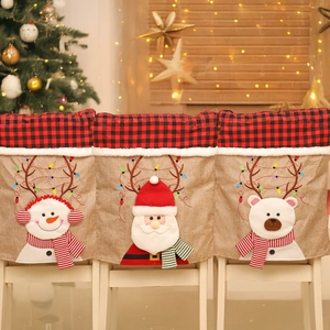 Detailed view of linen Christmas chair covers with Santa, Snowman and Reindeer motifs