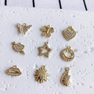 Set of 9 gold alloy charms featuring butterflies, stars, and hearts for DIY jewelry making