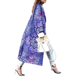 Detail of long-sleeved trench coat featuring purple mandala floral print and lapel collar