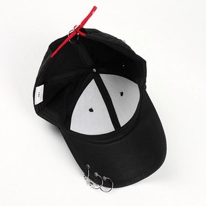 Black baseball cap with three silver rings on brim and red ribbon accessory
