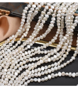 Macro view of irregular natural baroque freshwater pearls with milky white luster for DIY