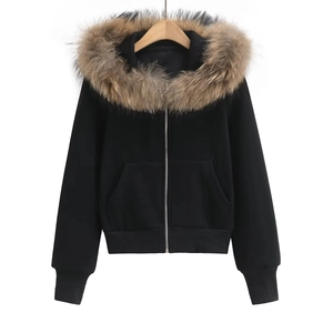Detail of a black hooded sweatshirt featuring a premium detachable brown faux fur collar