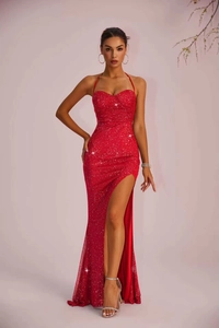 Detail view of red sequined slim-fit evening dress featuring a high side slit and halter neck