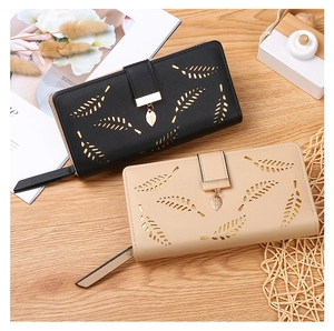 Detail of laser-cut leaf pattern on women long wallet with golden leaf metal pendant