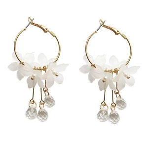 Elegant gold hoop earrings with white frosted flower petals and crystal pendants