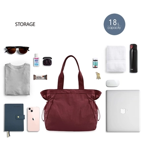 Flat lay of 18L waterproof tote bag with various travel essentials showing storage capacity