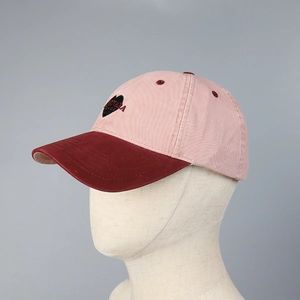 Detail view of contrast baseball cap with heart embroidery and washed cotton texture