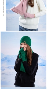 Winter knit set detail featuring pink and green beanies, fringed scarves and warm gloves