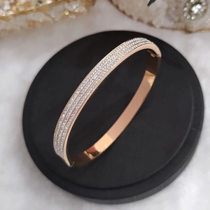 Rose gold stainless steel bracelet with three rows of white cubic zirconia stones