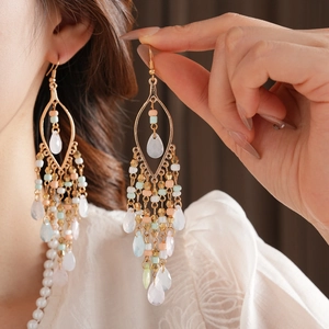 Detailed close-up of Bohemian tassel earrings with colorful beads and waterdrop pendants