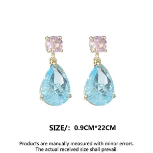 Pink and blue crystal teardrop earrings with gold setting on white background