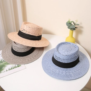 Drei Vintage Strohhüte in Beige, Grau und Blau mit schwarzen Bändern auf einem Tisch