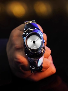 Macro detail of Y2K style silver metallic quartz watch with minimalist dial and blue lighting