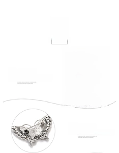 Macro detail of butterfly brooch showing rhinestone wings and secure silver alloy pin back