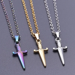 Detailed view of three polished sword pendants in rainbow, gold, and silver stainless steel