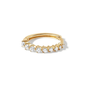 Macro shot of gold hinged hoop earring featuring clear stones on a white background
