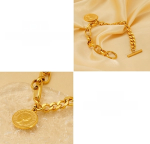 Detail of gold titanium steel chunky chain bracelet with Queen Elizabeth II coin charm