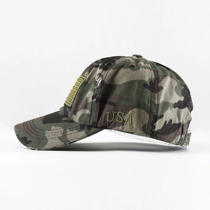 Close-up of USA embroidery and camouflage texture on a distressed cotton baseball cap