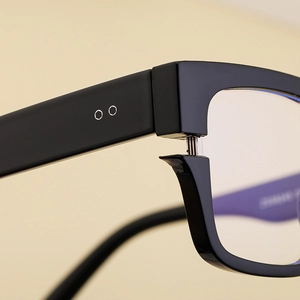 Close-up of the durable metal hinge and sleek black temple of these square sunglasses