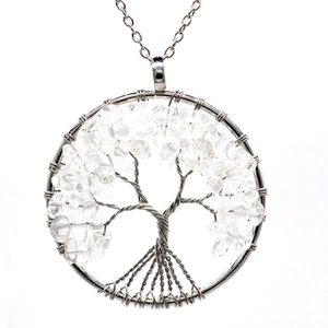 Macro shot of silver wire handmade tree of life pendant with white quartz stones
