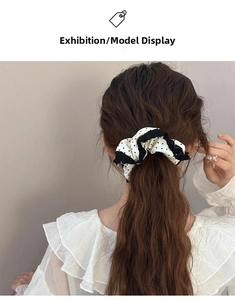 Close-up of black and white polka dot lace scrunchie styled on a ponytail back view