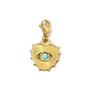 Macro view of gold heart lobster clasp charm with blue eye inlay for jewelry DIY