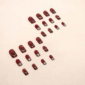 Sparkly burgundy press-on nails set with gold lines, pearls and glitter gradient finish