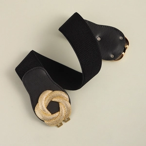 Close-up of elastic waistband with elegant gold spiral metal buckle and leather ends