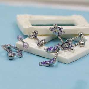 Exquisite silver nipple rings with purple zircon heart and butterfly shapes on blue background