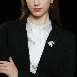 Anthropomorphic white tooth brooch with blue hat pinned on a professional black blazer lapel