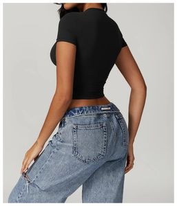 Close-up of black slim fit yoga t-shirt paired with distressed light blue jeans