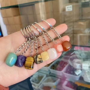 Handheld display of various irregular natural crystal and agate stone keychains