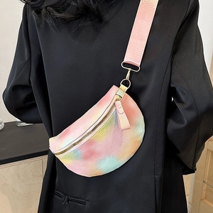 Rainbow tie-dye crescent crossbody bag with pink strap on professional model