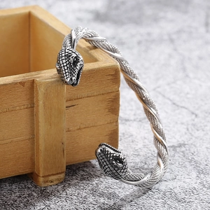 Macro detail of retro steel cable bracelet with intricately carved snake head design