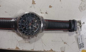 Macro detail of MEGIR men's sports watch with black dial and red stitching strap
